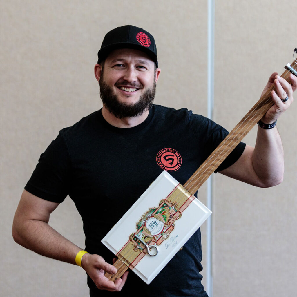 Workshop attendee with his cigar box guitar