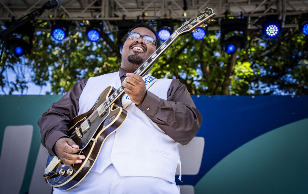 DK Harrell playing guitar on stage.