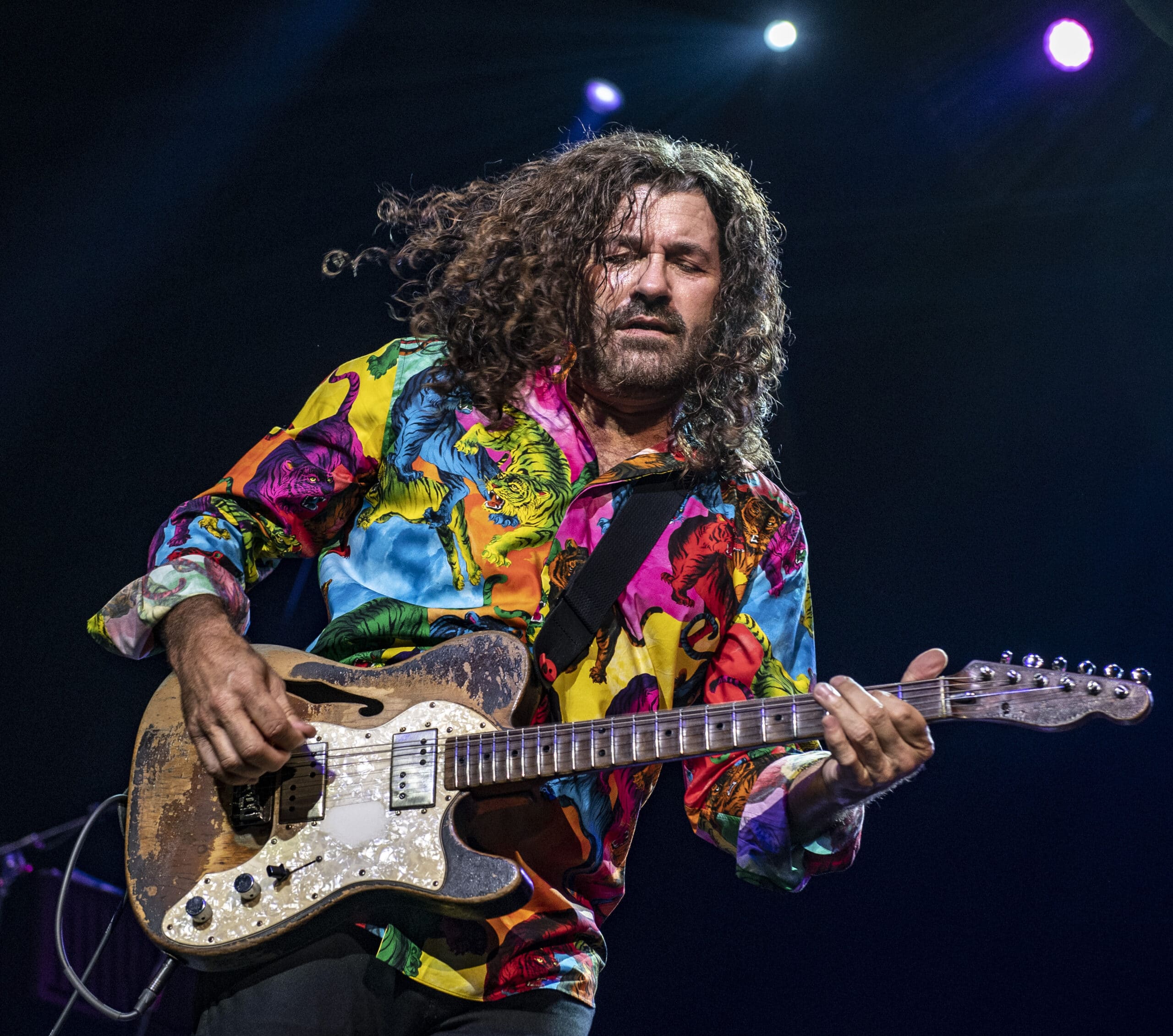 Tab Benoit playing guitar on stage