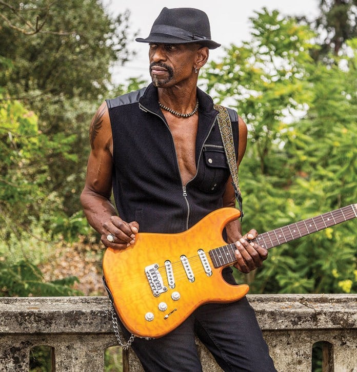 Dennis Jones holding his guitar